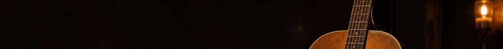 Guitar and lamp in a warm dark room